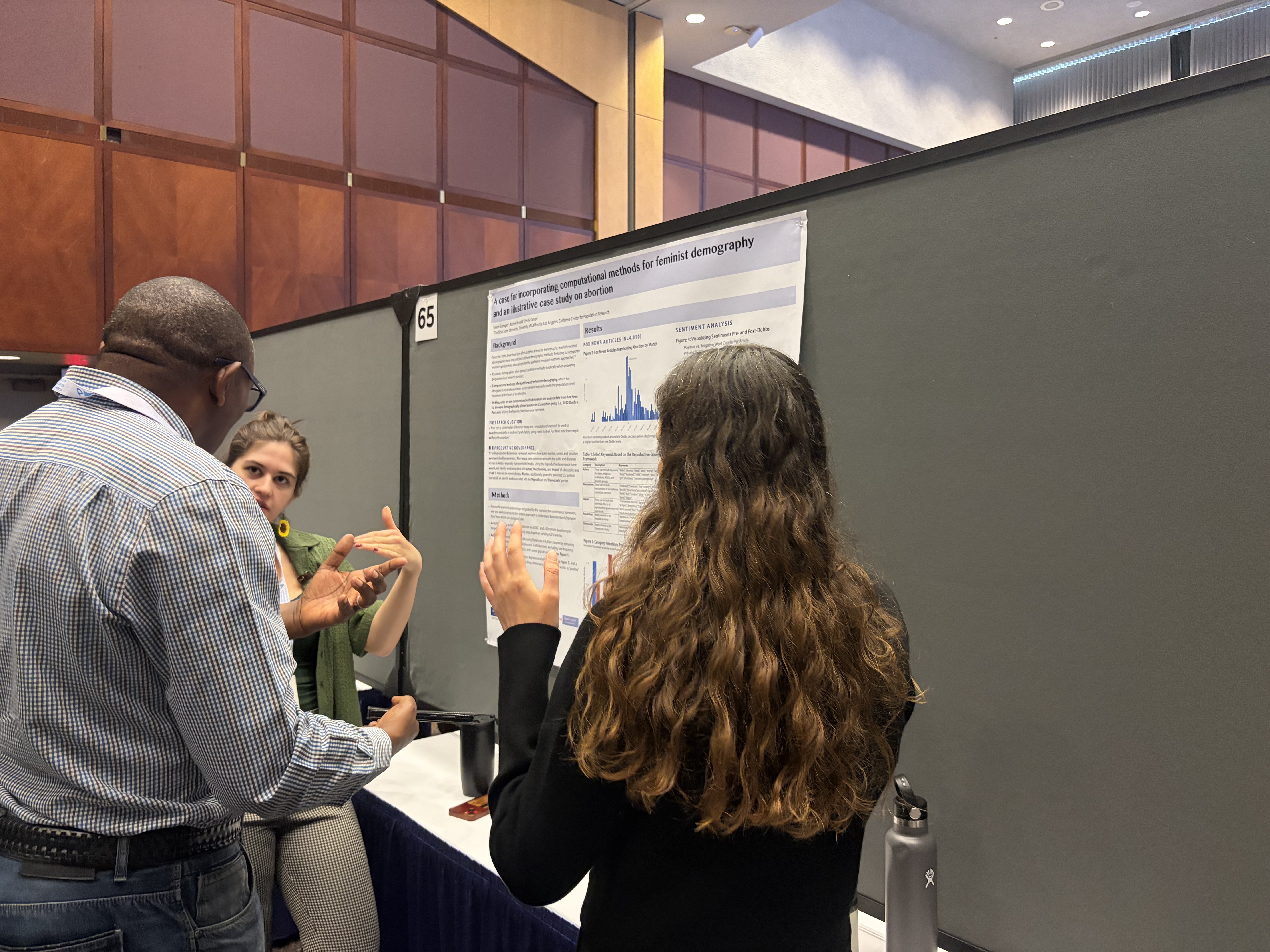 Sinem discussing results with conference attendees
